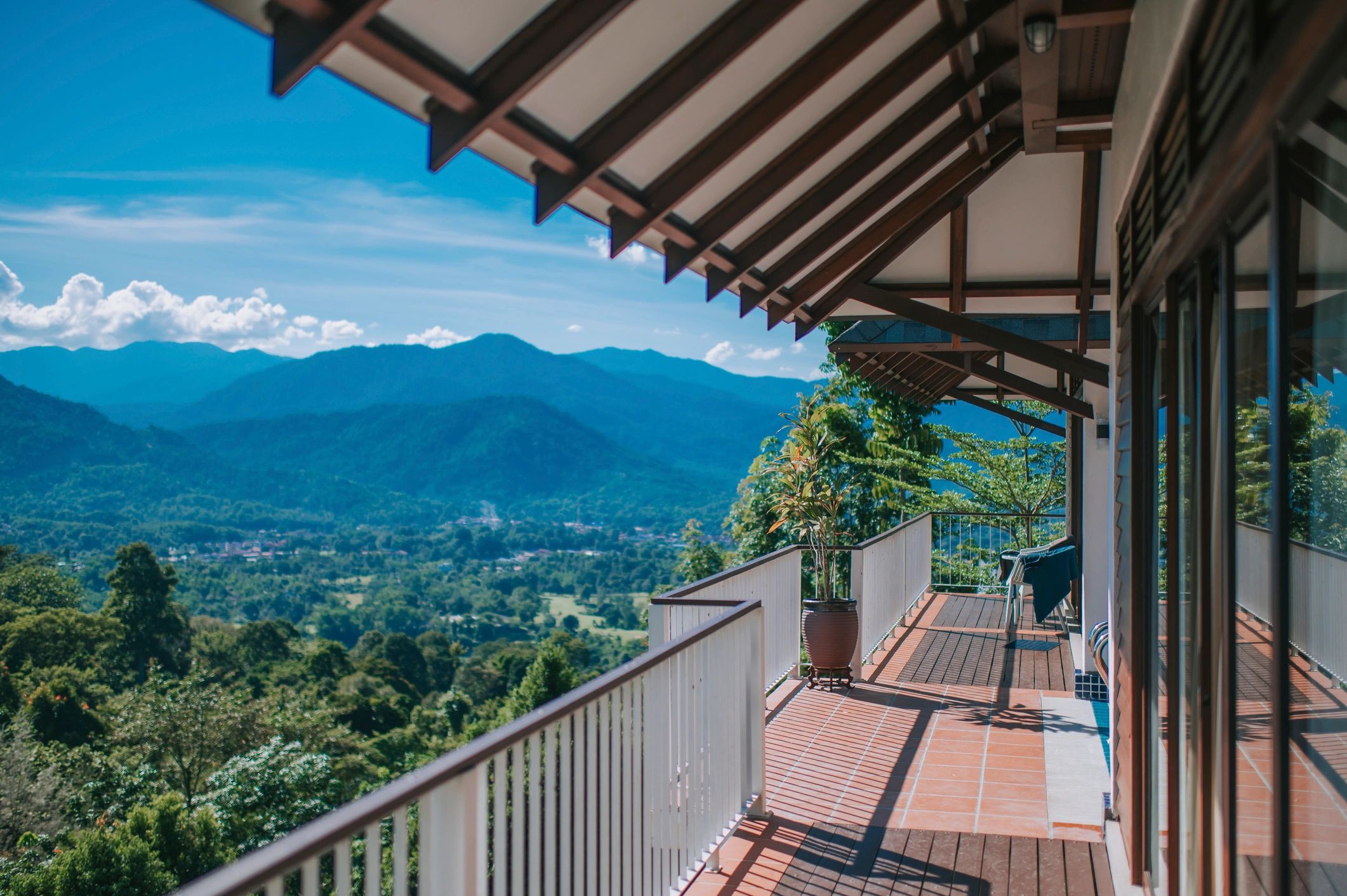 Mountain and forest view from a villa balcony