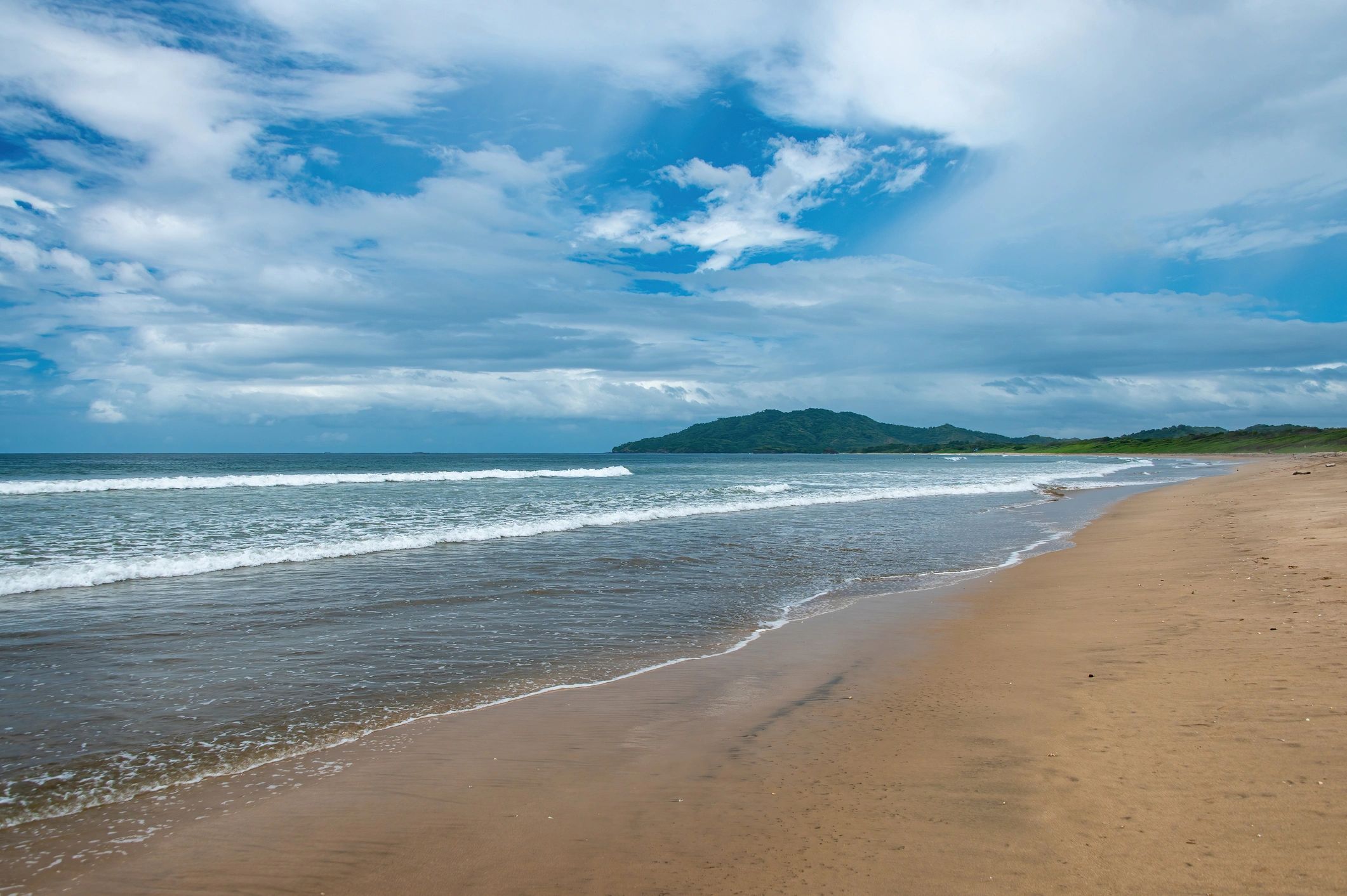 Long, sandy Costa Rican beach with gentle waves