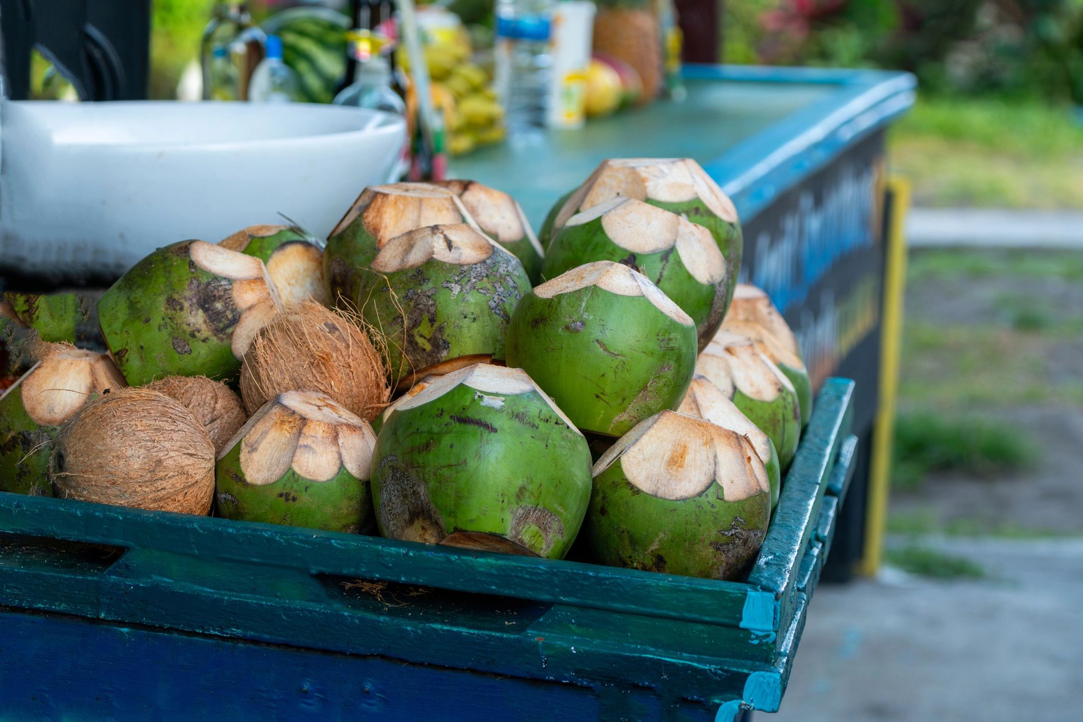Fresh coconuts prepared at a local market stall in Costa Rica
