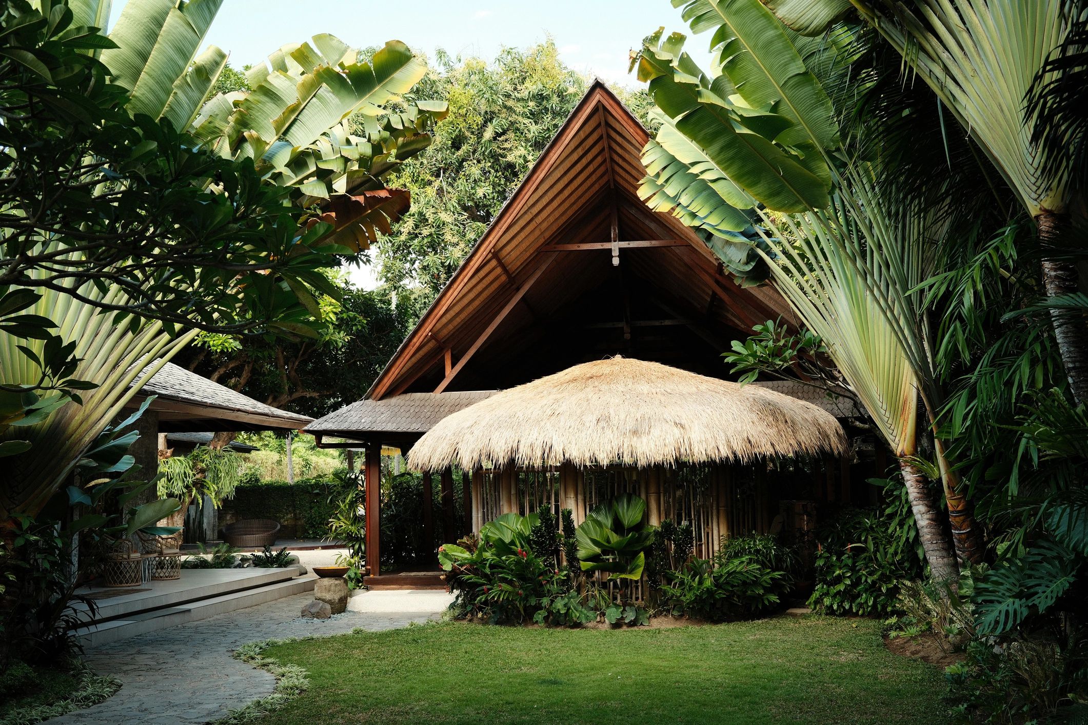 Tropical resort villa exterior with lush garden